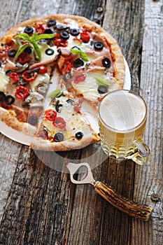 Appetizer: pizza and mug of lager beer