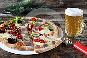 Appetizer: pizza and mug of lager beer