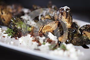 An appetizer plate of roasted Brussels Sprouts garnished with Fe