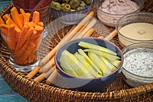 Appetizer platter consisting of sausage, breadsticks and sauces