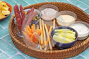 Appetizer platter consisting of sausage, breadsticks and sauces
