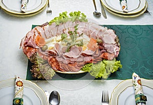 Appetizer platter surrounded with partially visible tableware.