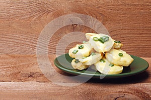 Appetizer of potatoes, cheese and green onions. There is room for text