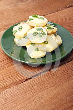 Appetizer of potatoes, cheese and green onions. There is room for text