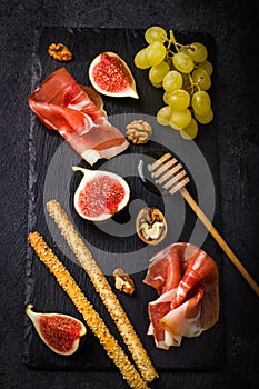 Appetizer. Prosciutto, figs, grape and grissini