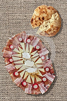 Appetizer Savory Dish Meze And Torn Flatbread Loaf Set On Bleached Jute Canvas Backdrop