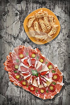 Appetizer Savory Dish Meze and Traditional Cheese Roll Pie Set on Rustic Old Weathered Cracked Pinewood Vignette Backdrop