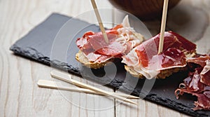 Appetizer Serrano ham with toasted bread