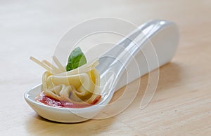 Appetizer spoon tortellini photo