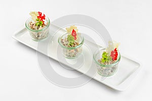 Appetizer vegetable salad in glass on white background. Catering service