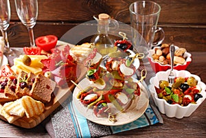 Appetizers and antipasti on wooden table