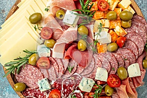 Appetizers or antipasto set with gourmet food. Mixed delicatessen of cheese and meat snacks, Food recipe background. Close up