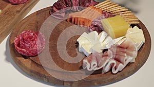 Appetizers boards with assorted cheese, meat, grape and nuts. Charcuterie and cheese platter. Speed Motion