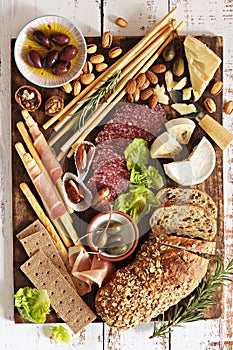 Appetizers platter with various of cheese, curred meat, sausage, olives, nuts and fruits