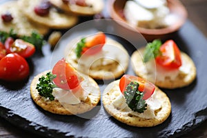 Appetizers and Snacks, crackers, dried fruit, tomatoes, parsley, and cream cheese