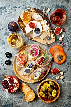 Appetizers table with italian antipasti snacks. Brushetta or authentic traditional spanish tapas set, cheese variety board