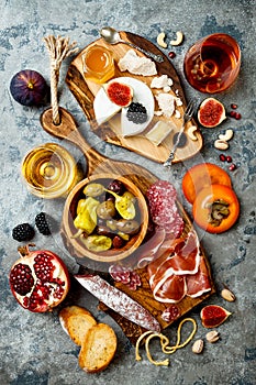 Appetizers table with italian antipasti snacks and wine in glasses. Brushetta or authentic traditional spanish tapas set