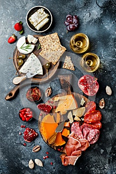 Appetizers table with italian antipasti snacks and wine in glasses. Brushetta or authentic traditional spanish tapas set