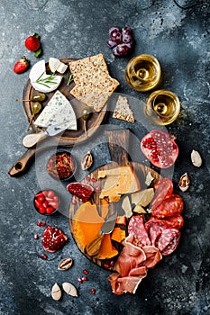 Appetizers table with italian antipasti snacks and wine in glasses. Brushetta or authentic traditional spanish tapas set