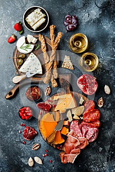 Appetizers table with italian antipasti snacks and wine in glasses. Brushetta or authentic traditional spanish tapas set