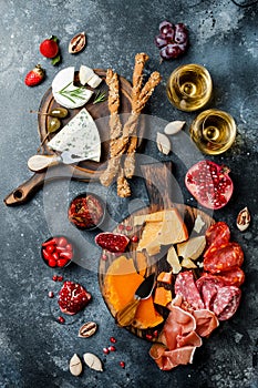 Appetizers table with italian antipasti snacks and wine in glasses. Brushetta or authentic traditional spanish tapas set