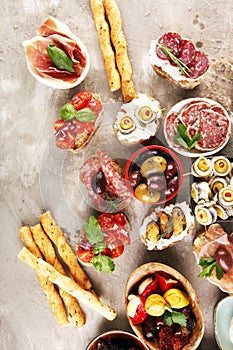 Appetizers table with italian antipasti snacks and wine in glasses. Brushetta or authentic traditional spanish tapas set, cheese