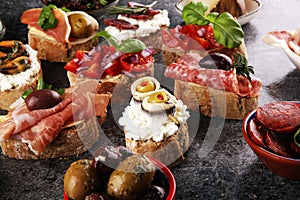 Appetizers table with italian antipasti snacks and wine in glasses. Brushetta or authentic traditional spanish tapas set, cheese