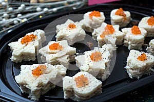appetizers toast with salmon and lumpfish roe in a black plate