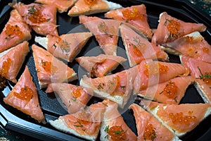 appetizers toast with salmon and lumpfish roe in a black plate lumpfish roe