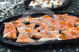 appetizers toast with salmon and lumpfish roe in a black plate lumpfish roe