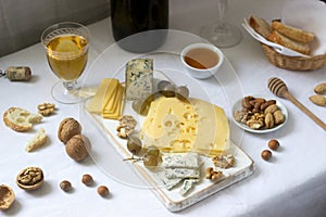 Appetizers of various types of cheese, grapes, nuts and honey, served with white and red wine. Rustic style