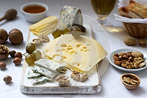 Appetizers of various types of cheese, grapes, nuts and honey, served with white and red wine. Rustic style