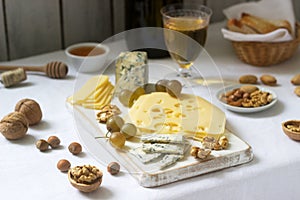 Appetizers of various types of cheese, grapes, nuts and honey, served with white and red wine. Rustic style