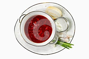 Appetizing borsch with garlic and sour cream in a plate. Traditional Russian cuisine. Top view. Isolated over white background