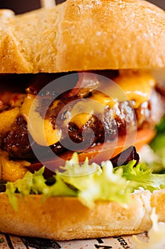 Appetizing burger with fresh tomatoes and lettuce