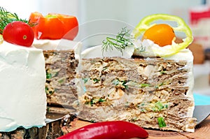 Appetizing cake with chicken meat, eggs and salad. Snack unsweetened cake
