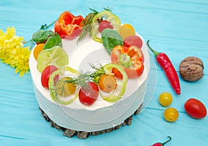 Appetizing cake with chicken meat, eggs and salad. Snack unsweetened cake. Wooden board with hot peppers and tomatoes