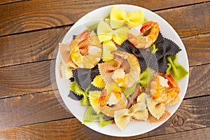 Appetizing colored farfalle pasta with chrimp photo