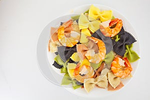 Appetizing colored farfalle pasta with chrimp photo