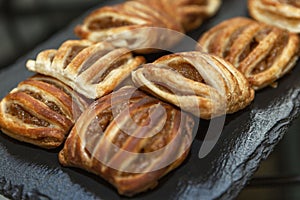 Appetizing crispy pastries with jam on a black stone tray. Organizing events and business meetings. Close-up