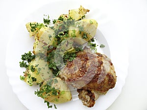 Appetizing dish - baked chicken and potatoes on a platter.