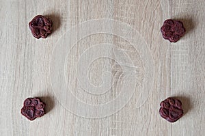 appetizing dog muffins on wooden background. dog birthday. red velvet. paw shaped dog treat. homemade dog biscuit. paw bakery