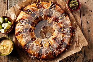 Appetizing enchilada ring with cheese and sauces