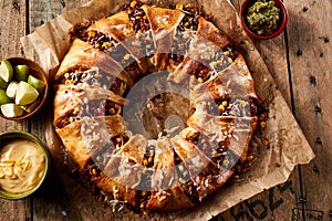 Appetizing enchilada ring with cheese and sauces photo