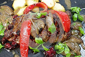 Appetizing food  loin  with vegetables and  boletus