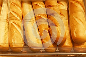 Appetizing fresh baguettes on the counter in a store. Delicious traditional breakfast pastries. Close-up