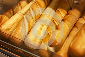 Appetizing fresh baguettes on the counter. Traditional breakfast pastries. Close-up