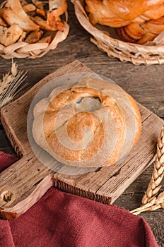 Appetizing fresh culinary pastry - beautiful curly pie with filling on wooden