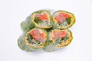 Rolls with red fish rice and vegetables wrapped in lettuce