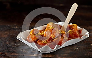 Appetizing fried pork sausage pieces with curry ketchup
